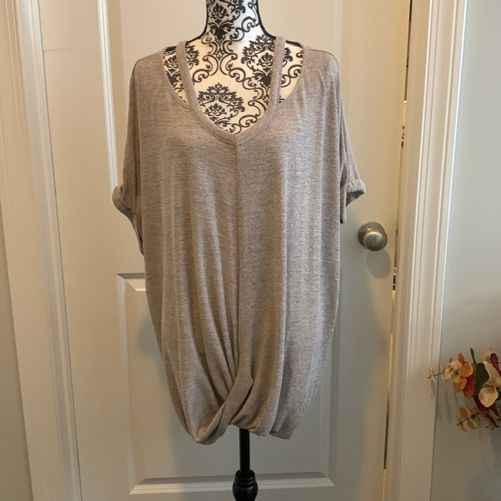 NWOT.  Woman’s short sleeve cut out neckline top with twisted front hemline.
